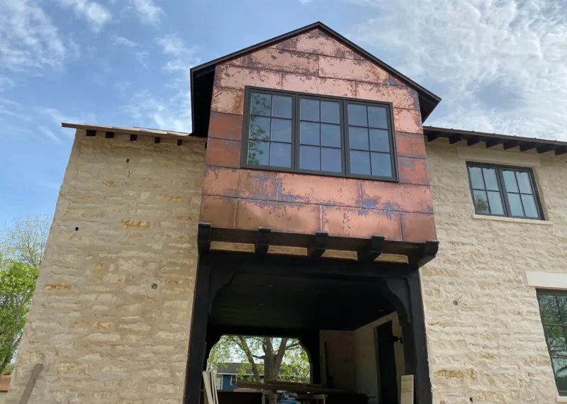 Copper metal panel facade on a stone building for Skylight Installation in Longmeadow